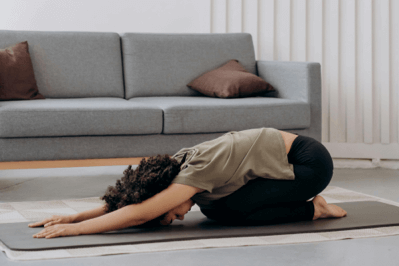 A woman stretching on a yoga mat