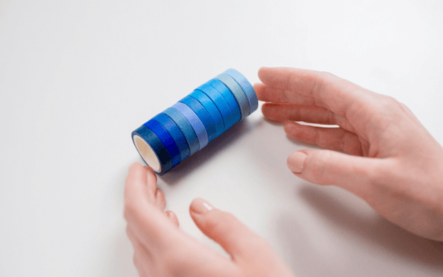 Hand holding colorful washi tapes