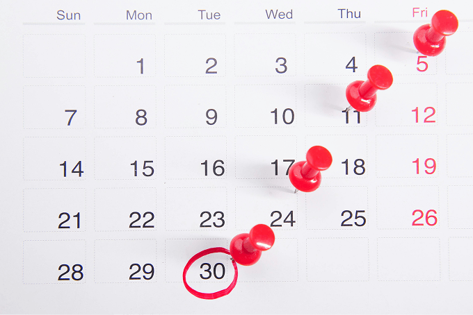 A calendar with pins on important dates