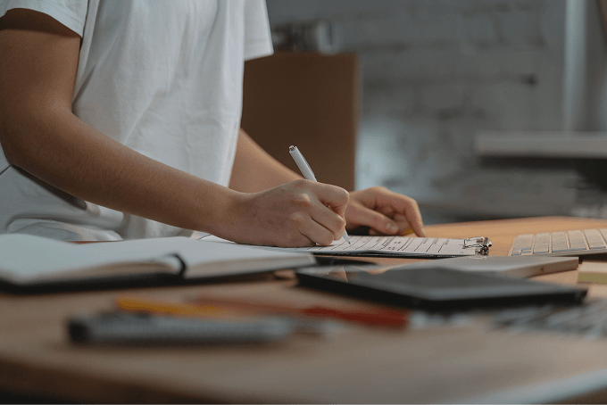 A person writing in a notebook