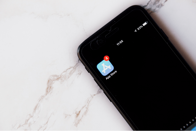 A mobile phone on a table with the App Store logo on the screen