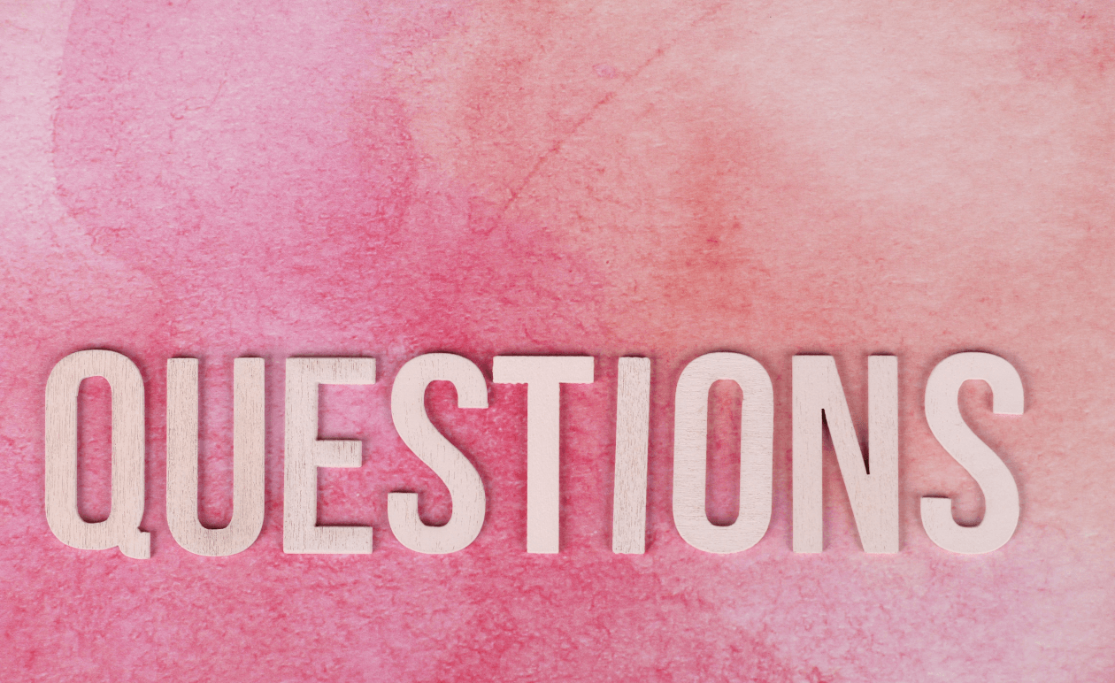 The word questions on a pink background