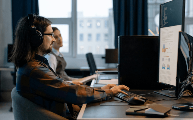 A person working in an office on a computer