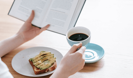 Person drinking coffee and reading