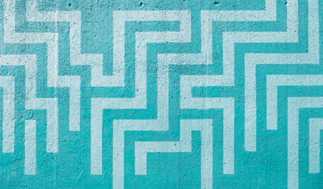 A wall painted with a geometric pattern of maze