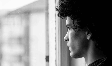 A man is looking from the window